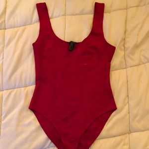 Red body suit with a round neckline